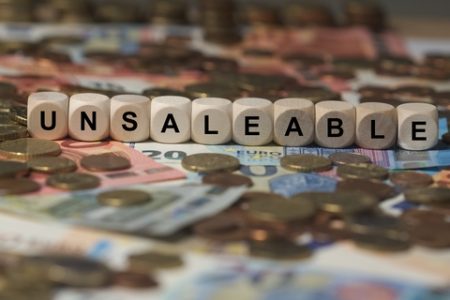 unsaleable - cube with letters, money sector terms - sign with wooden cubes